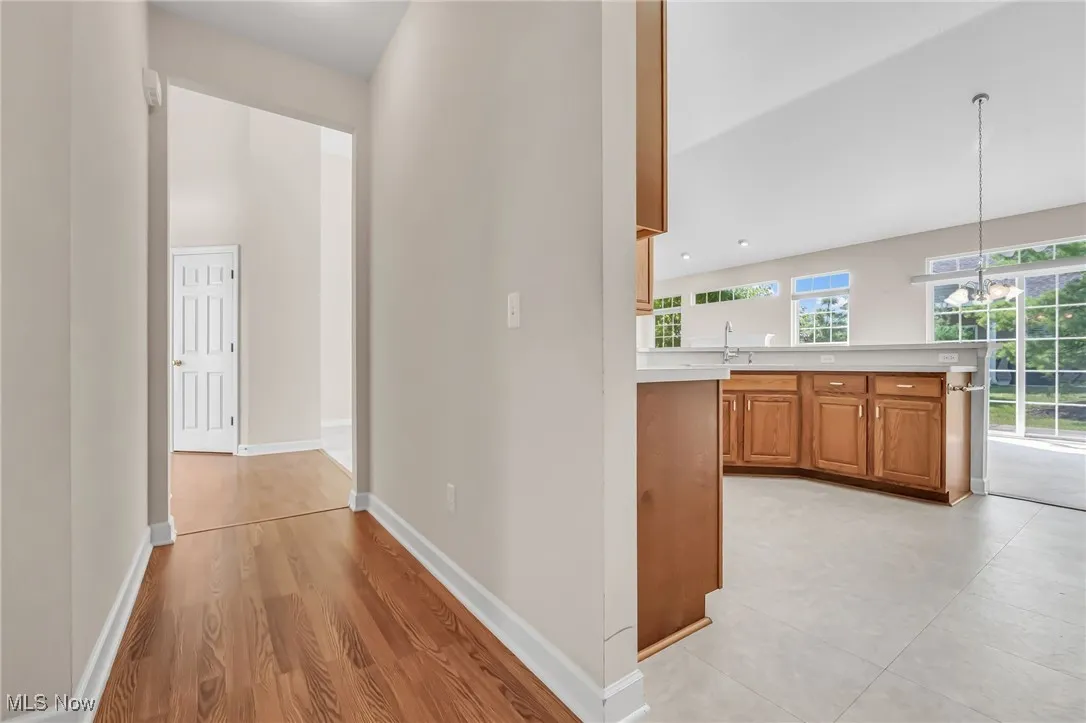 Hall with light wood-style floors and recessed lighting