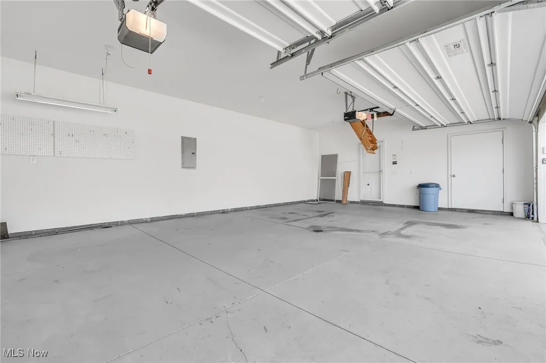 Garage with a garage door opener and electric panel