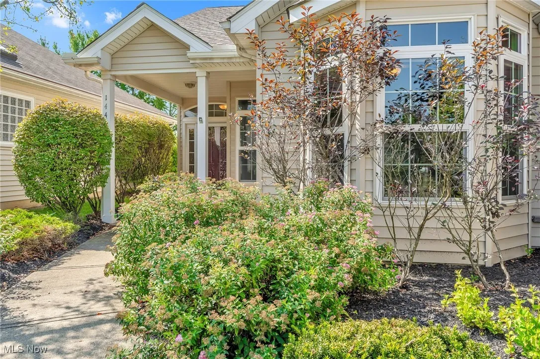 Doorway to property with roof with shingles