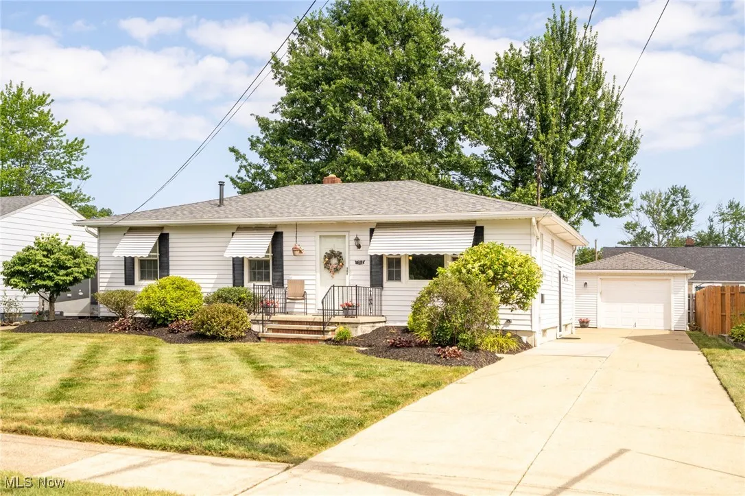1312 W 35th has a concrete driveway and a garage.