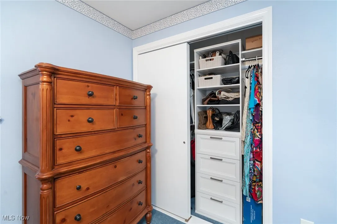 One of two organized closets in the primary bedroom