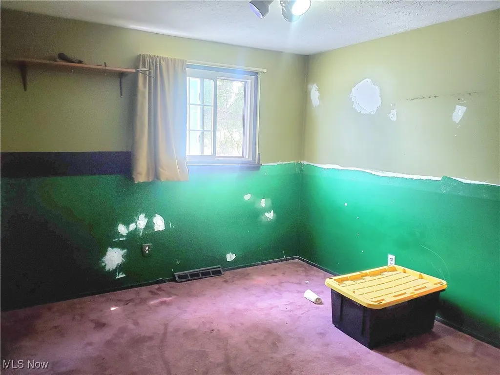 Unfurnished bedroom featuring carpet floors and a textured ceiling