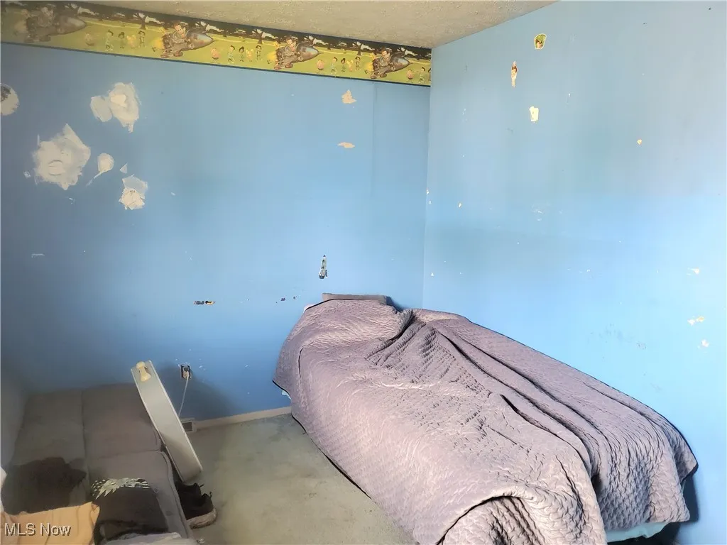 Carpeted bedroom with baseboards