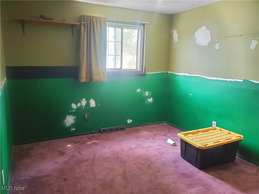 Unfurnished bedroom with carpet flooring and baseboards