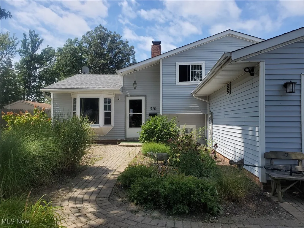 Rear view of property featuring a chimney