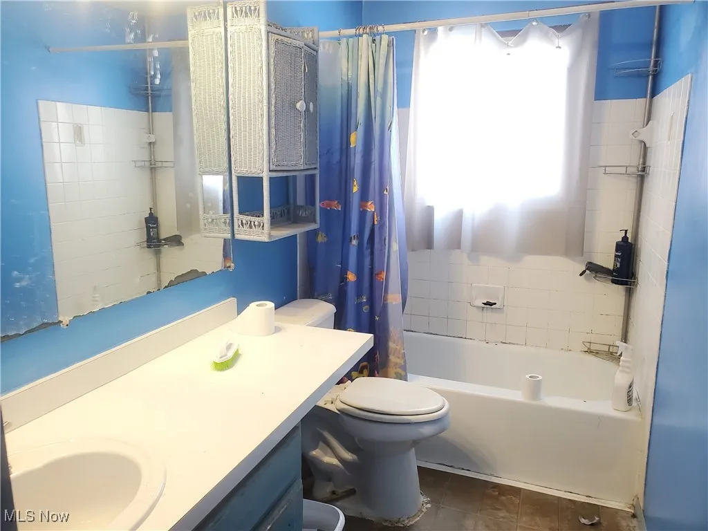 Bathroom featuring shower / bath combo and vanity