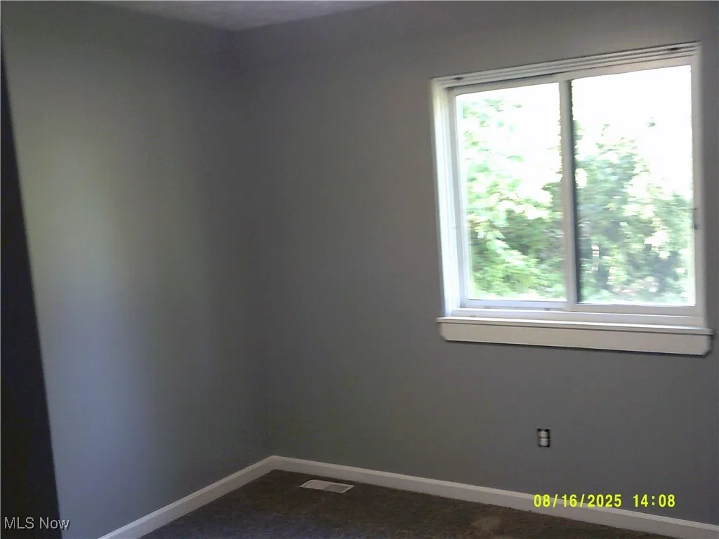 Spare room featuring baseboards