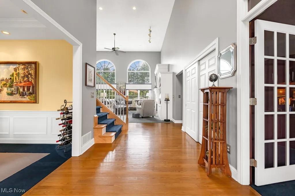 Entrance foyer featuring light wood-style flooring, ceiling fan, recessed lighting, and stairway