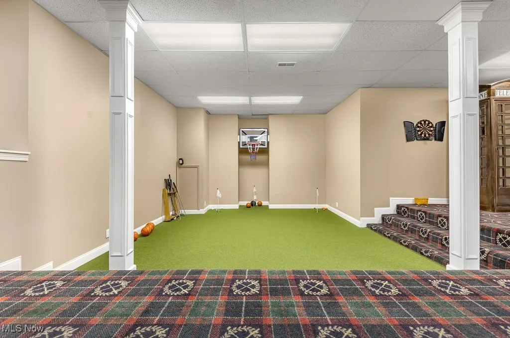 Basement featuring carpet floors and a paneled ceiling