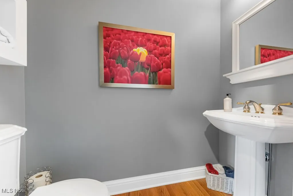 Bathroom featuring toilet and light wood-type flooring