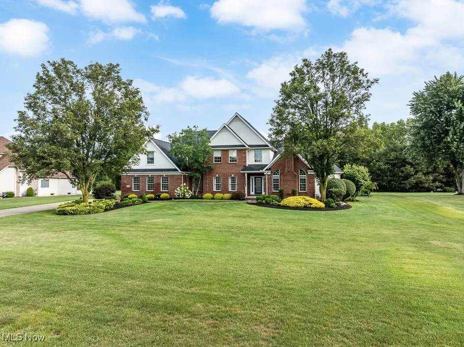 View of front of house with a front lawn and brick siding