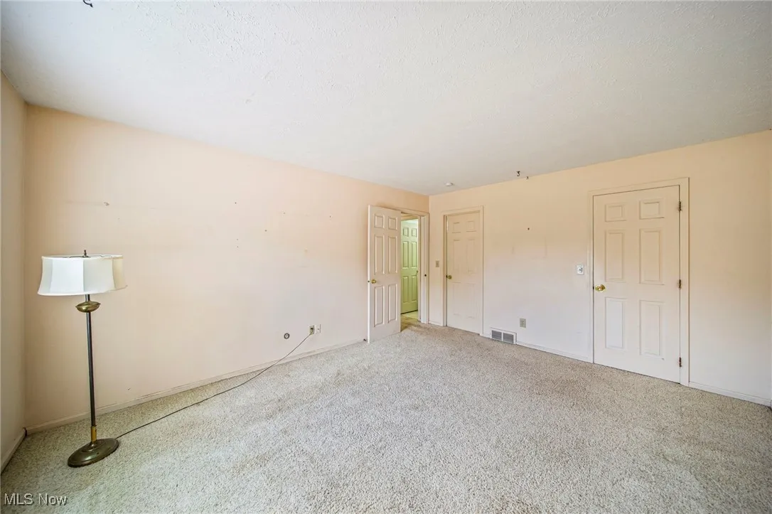 Unfurnished bedroom with carpet and a textured ceiling
