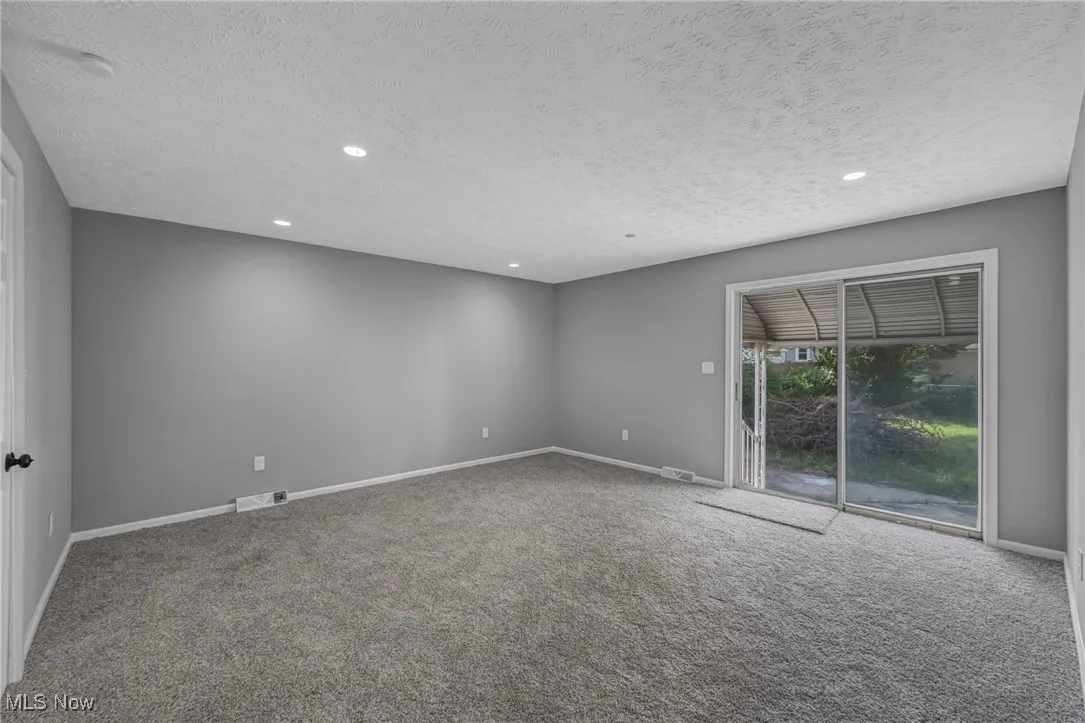 Spare room with carpet flooring, recessed lighting, and a textured ceiling