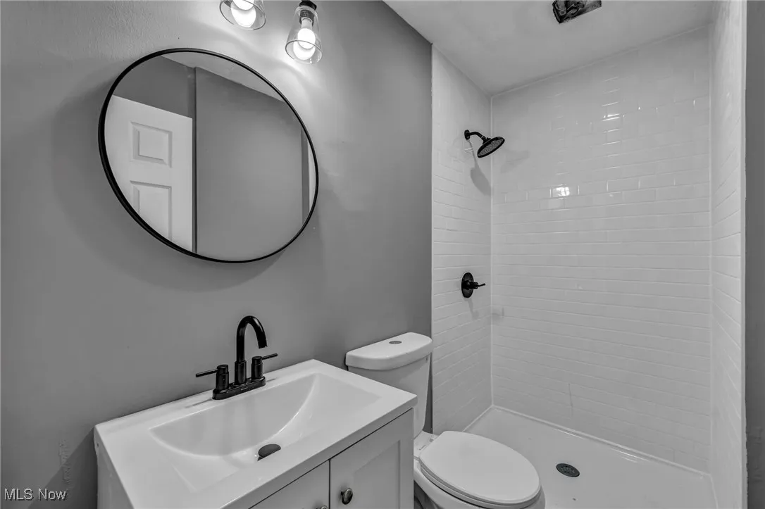 Full bath featuring vanity and a shower stall