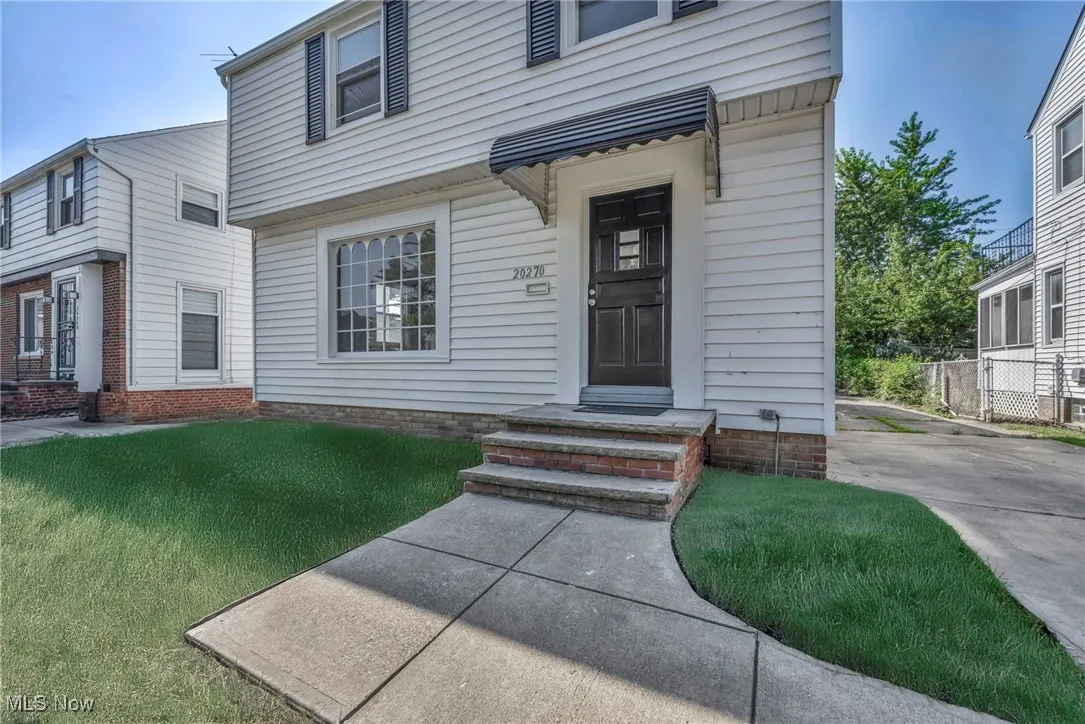 Doorway to property with a yard
