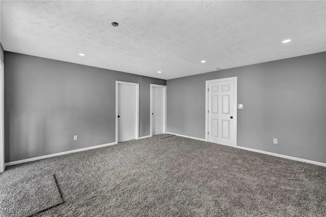 Unfurnished bedroom featuring carpet floors, recessed lighting, and a textured ceiling