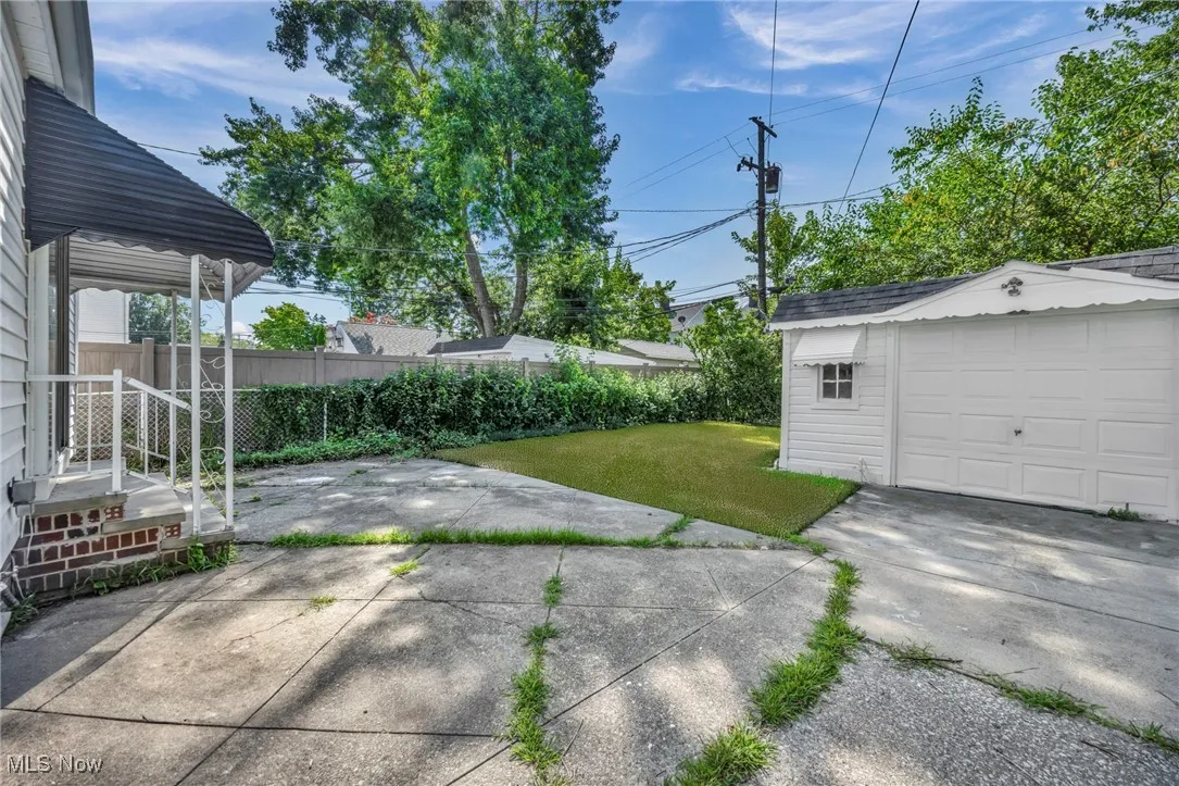 View of yard featuring an outbuilding, driveway, and a detached garage