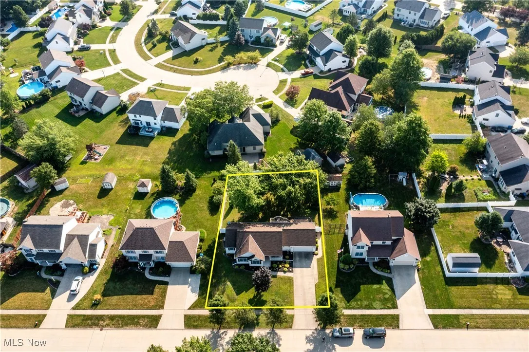 Aerial perspective of suburban area featuring a pool and property boundaries highlighted
