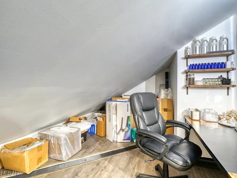 Office/storage area with wood finished floors and lofted ceiling