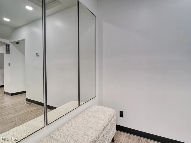 Bathroom with light wood-style flooring and recessed lighting
