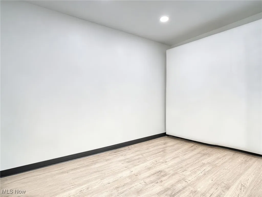 virtually cleared room-Unfurnished room featuring light wood-style flooring and baseboards