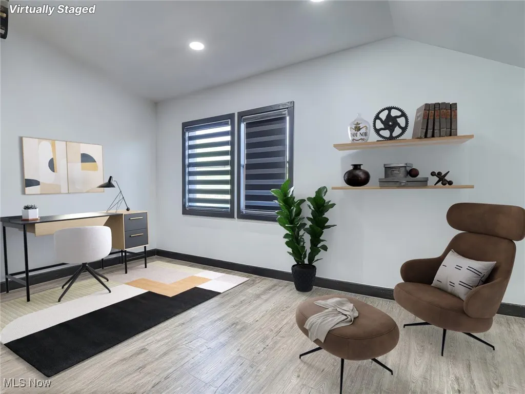 virtually staged- room featuring light wood-type flooring, an office area, and recessed lighting