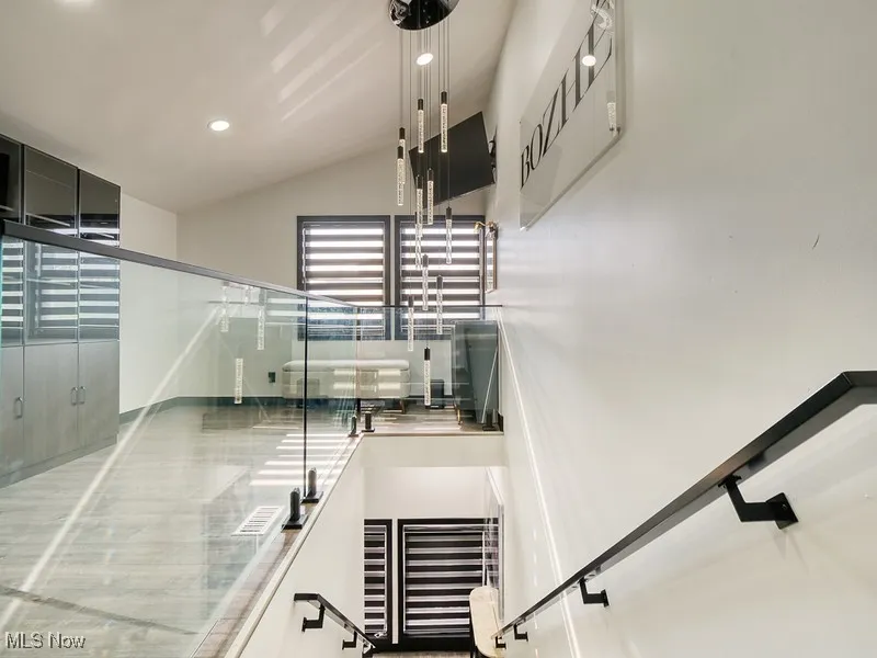 Stairs with recessed lighting, lofted ceiling
