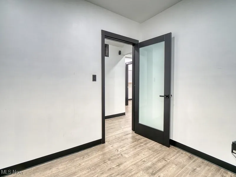 Empty room with light wood-style floors and baseboards