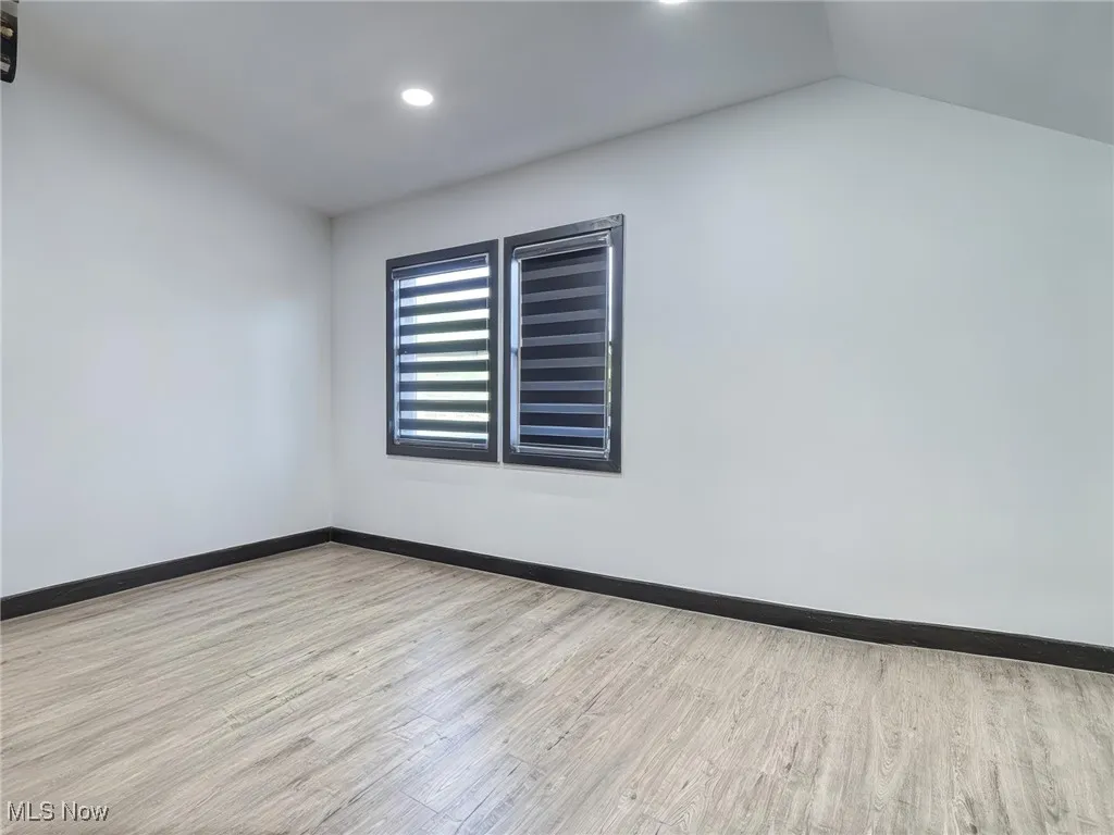 virtually cleared room featuring light wood finished floors and recessed lighting