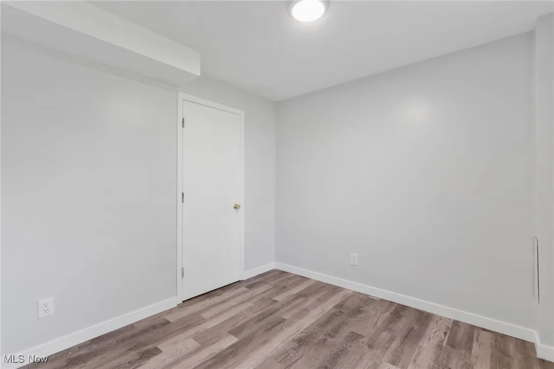 Empty room with baseboards and light wood-style floors