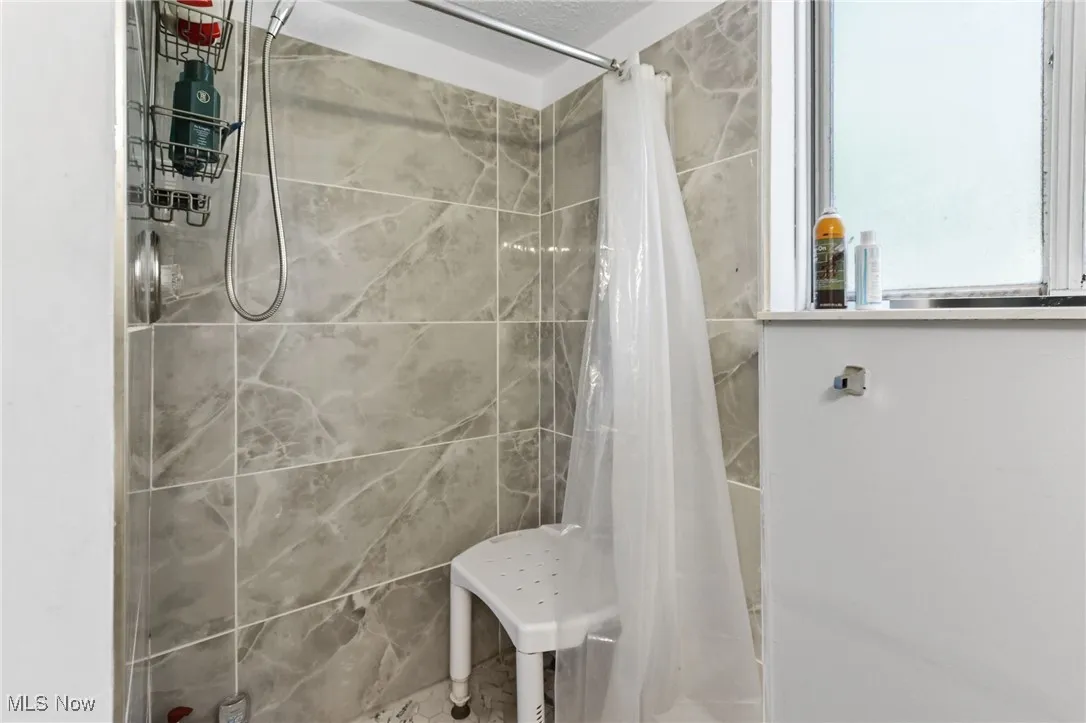 Bathroom featuring tiled shower