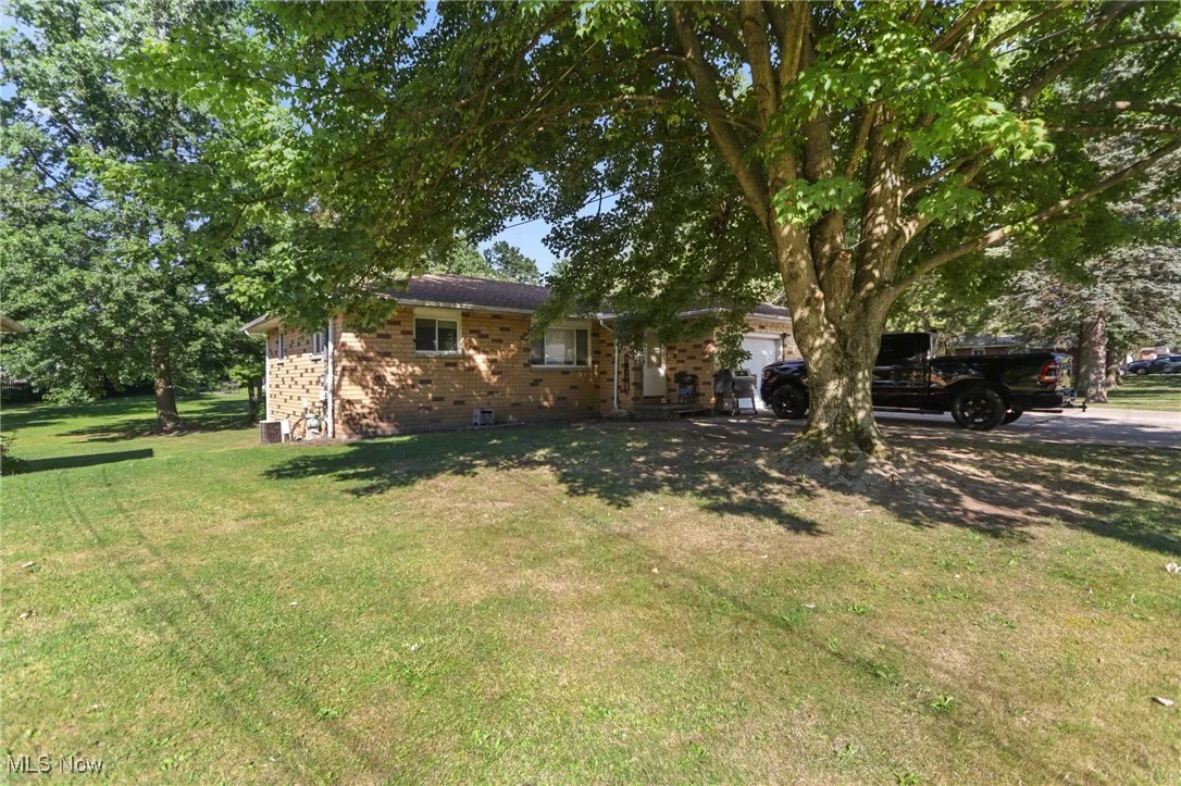 View of front facade with brick siding and a front lawn