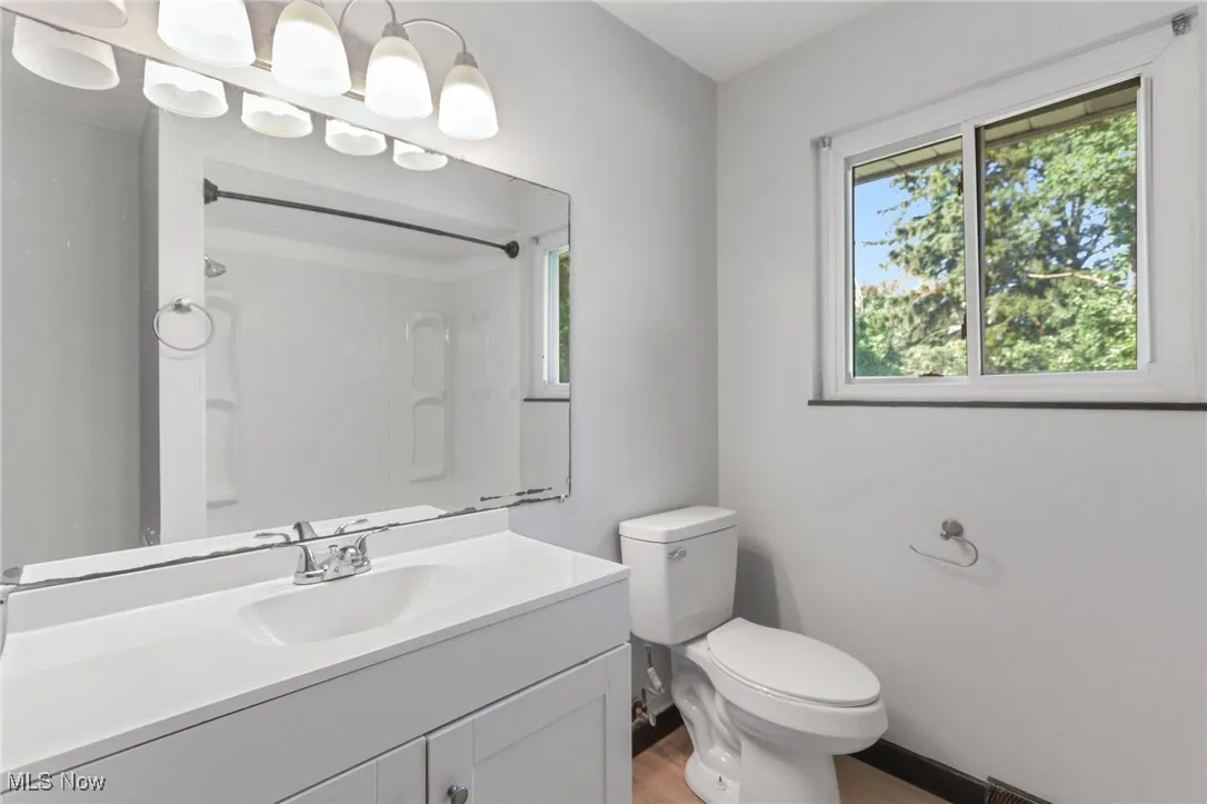 Bathroom featuring vanity, light wood-style flooring, and a shower