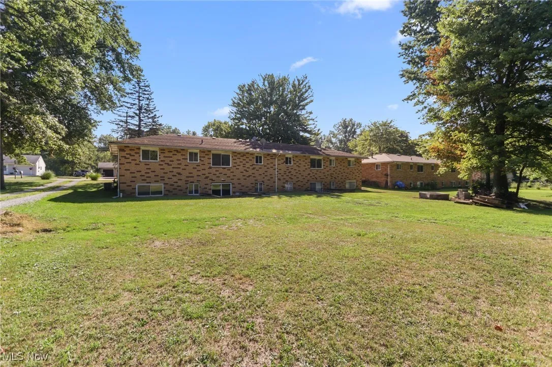 Rear view of house with a yard