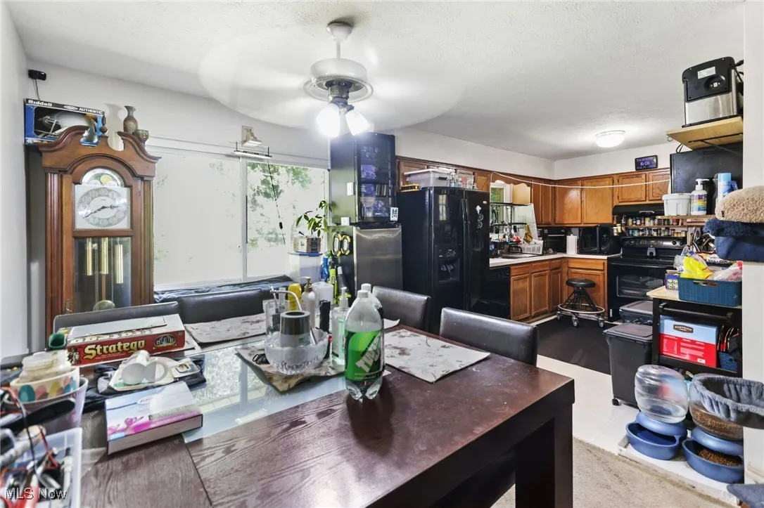 Dining space featuring a ceiling fan and a textured ceiling