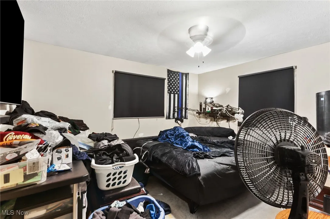 Bedroom featuring a textured ceiling and a ceiling fan
