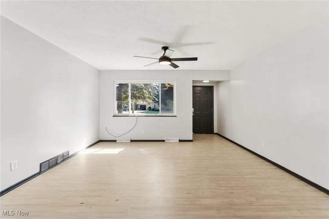 Spare room with light wood-style floors and ceiling fan