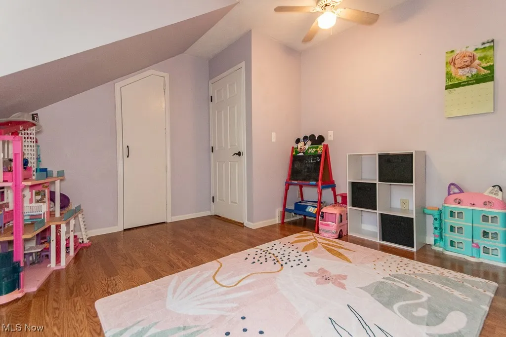 Rec room with wood finished floors, vaulted ceiling, and ceiling fan
