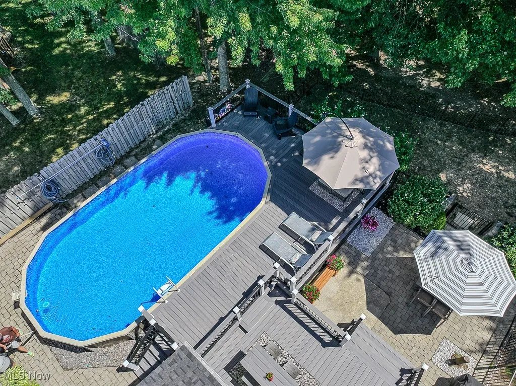 View of swimming pool with a fenced backyard, a deck, and a patio