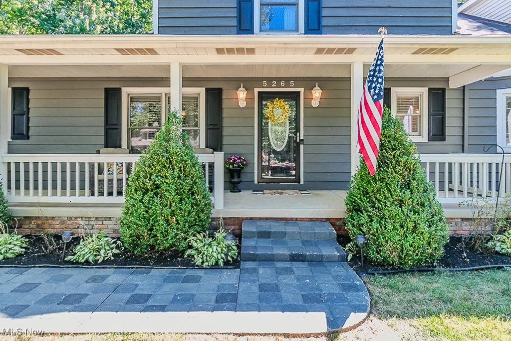 View of exterior entry with covered porch