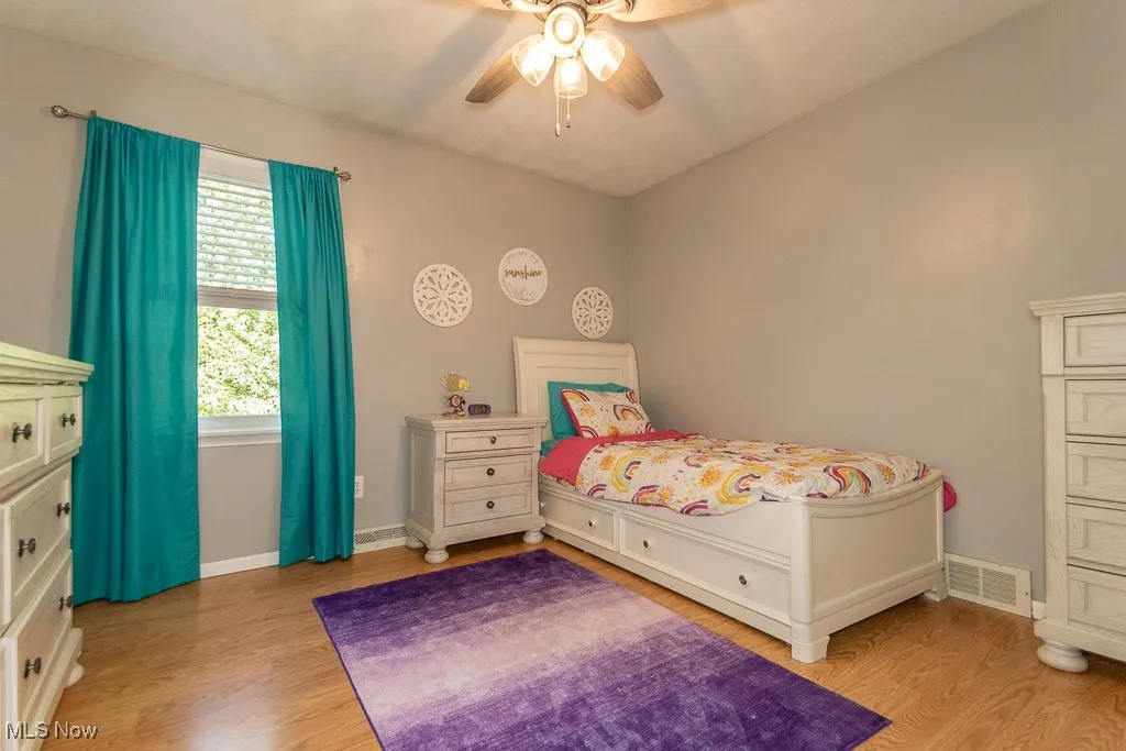 Bedroom featuring light wood-style flooring and a ceiling fan