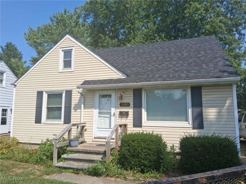 View of front of property featuring roof with shingles
