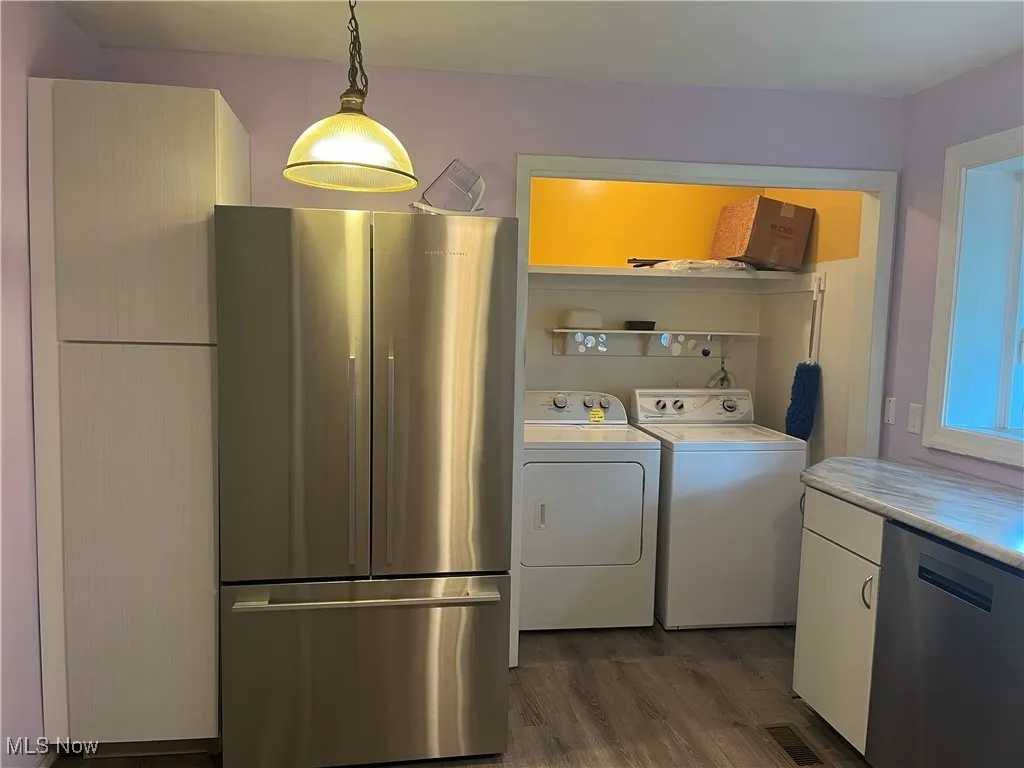 New stainless fridge next to second pantry in kitchen.  Laundry off kitchen.