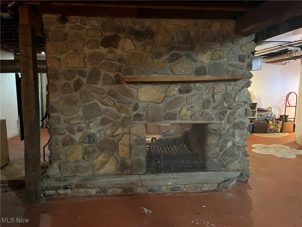 Large masonry stone woodburning see thru fireplace in bsmt.