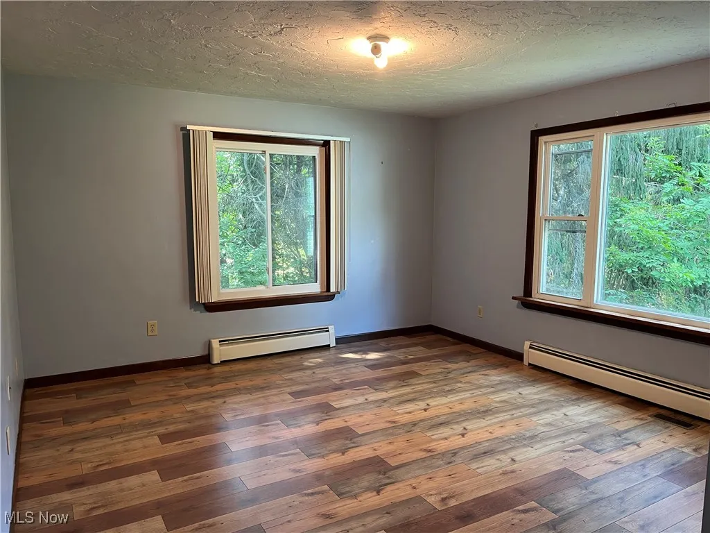 Bedroom three has tons of light and laminate flooring.