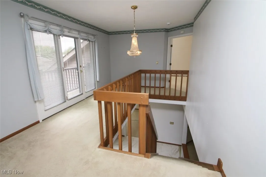 Loft area with doors that open to a small balcony