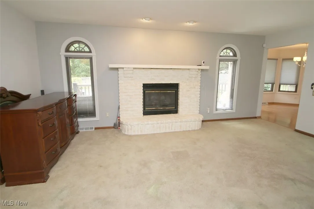 Family room over looking pool and a gas fireplace, and a chandelier