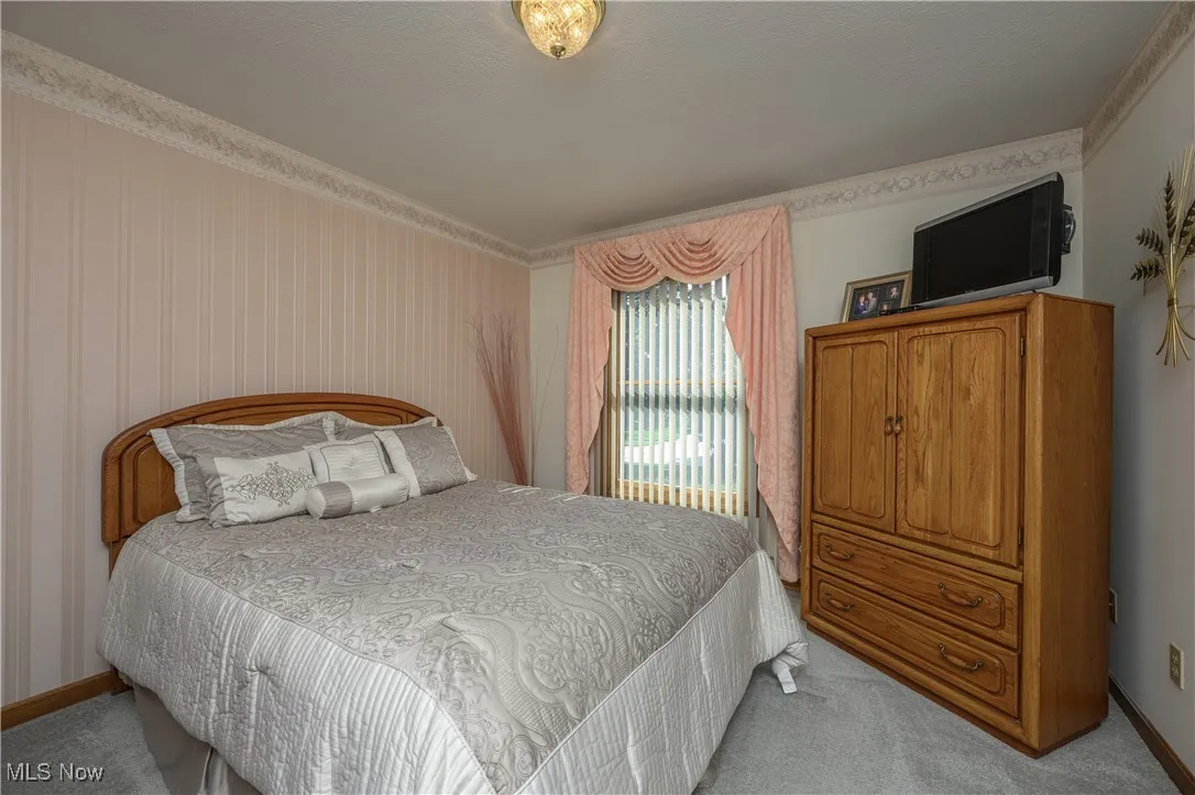 Bedroom with light colored carpet