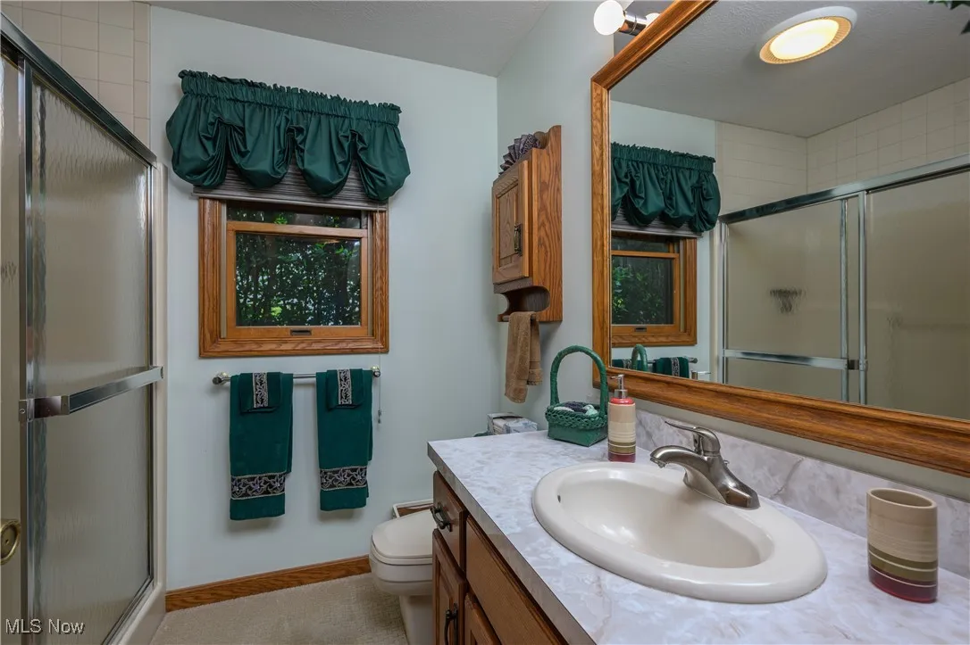 Full bathroom with a stall shower and vanity