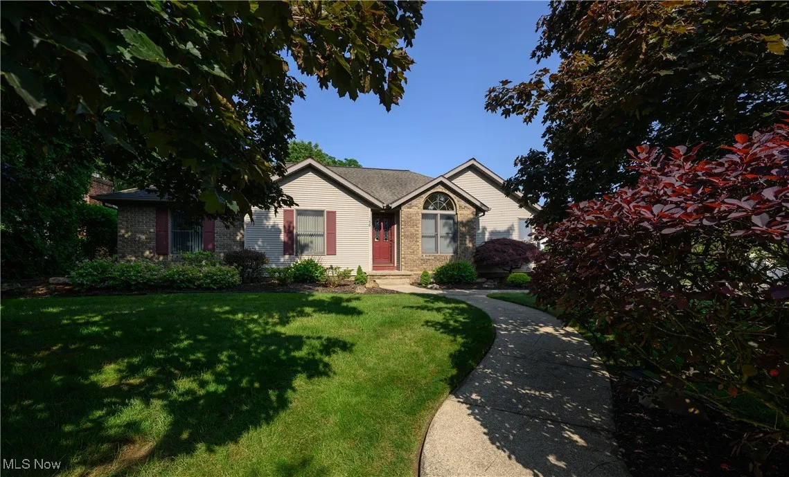 Ranch-style house with a front lawn and brick siding